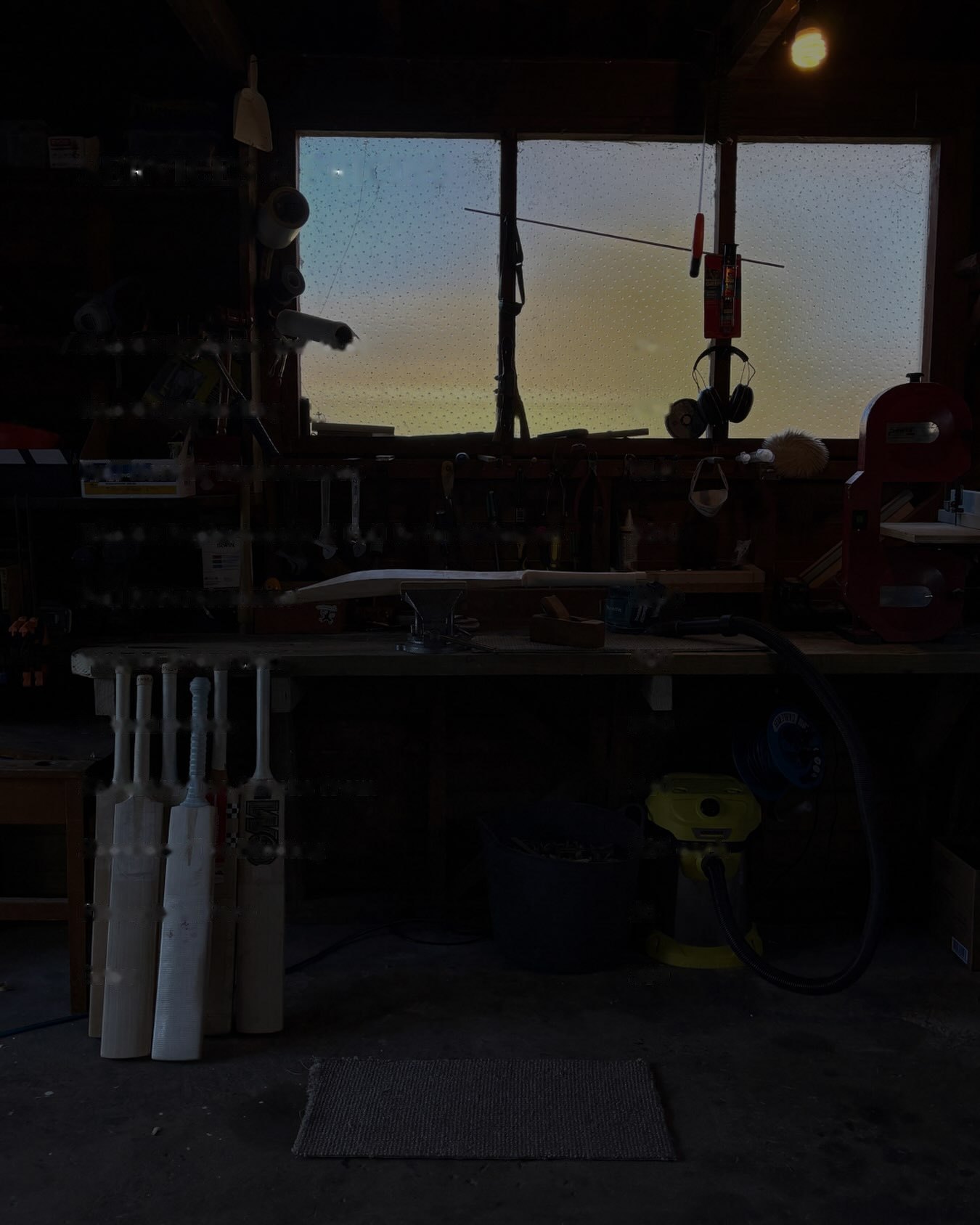 Harper Bat Repair workshop at dusk, bats leaning against the bench